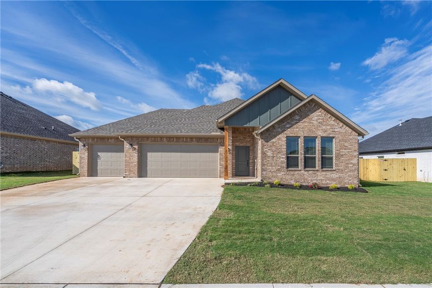 This stunning new construction home offers the perfect blend of style and functionality with two spacious living areas and designer finishes throughout. The main living room features a vaulted ceiling with a wood beam accent, large windows, and a striking fireplace with a stone surround and wood mantle. The second living area provides flexible space or a cozy retreat. The kitchen is beautifully designed with warm wood cabinetry, soft-close doors and drawers, quartz countertops, a gas range, and a statement black chandelier over the island. The primary suite offers a luxurious bath with a freestanding tub, fully tiled shower, dual sinks, and ample storage. Wood-look tile flows throughout the main areas, and extras include a mud bench, 3-car garage, solar decking in the attic, full sod, fence, and gutters.