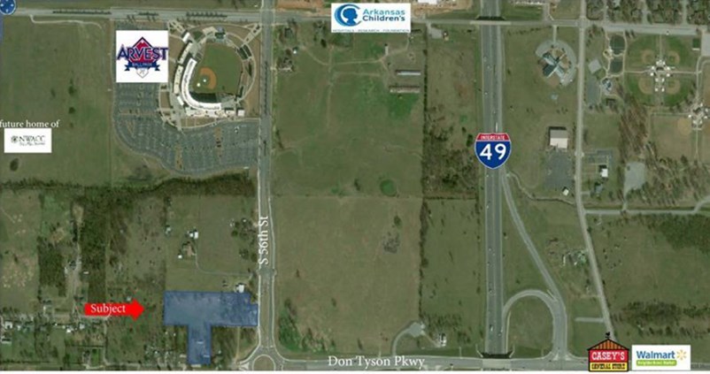 Look at the commercial/development potential on this 5+/- acres! Double entrance. Land goes around and reconnects to Don Tyson Pkwy. Great proximity to Arvest Ballpark, Children's Hospital and I-49. Commercial utilities already on property - sewer, water and electric. Can be re-zoned commercial upon ownership. 4BR, 2BA home over 2,400 sqft. Refrigerator is negotiable. All other appliances less than 1 year old. Carport on the backside.