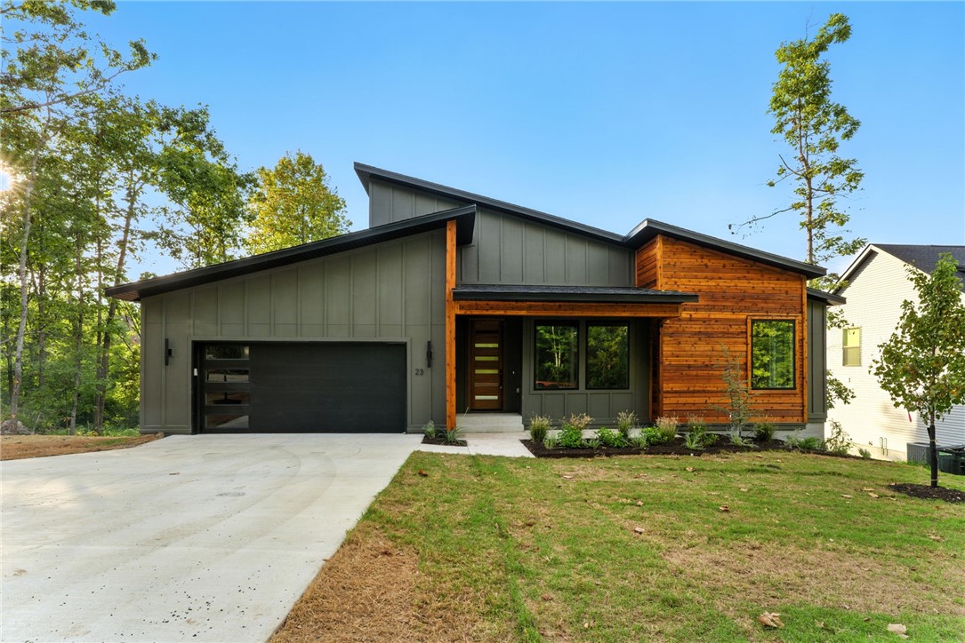 Contemporary new-construction in Bella Vista ā a 2 bed, 2 bath plus dedicated office in an amenity-rich community of lakes, trails and golf. This home stands apart with oak hardwoods throughout, oversized windows bathing rooms in natural light, and designer details at every turn. The chefās kitchen features a full tiled backsplash, quartz counters with custom oak accent and waterfall island. Oak-trimmed headers and accent beams in the living area and ownersā suite add warmth; full tiled showers and a striking tiled accent wall with top-of-the-line modern fireplace and oak mantel deliver luxe finishes. Additional upgrades include a gorgeous front entry door, upgraded modern garage door with sidelight glass, covered back deck, and a full mudroom with custom cubbies for effortless organization. Move-in ready and distinctly elevated.