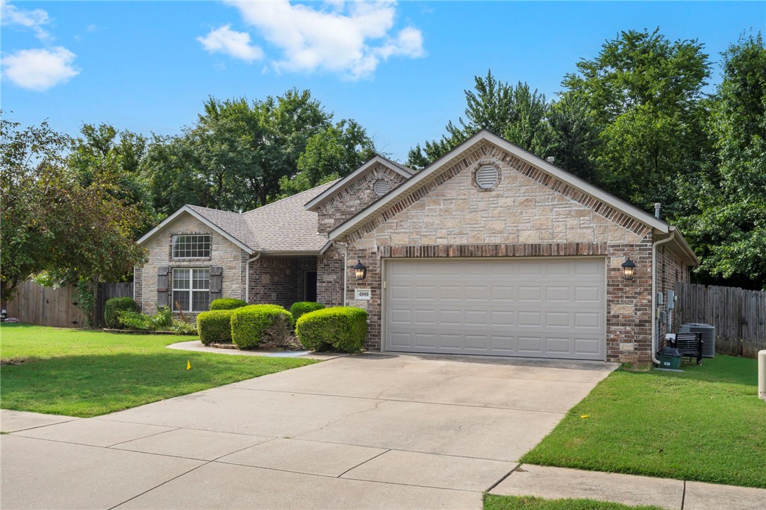 Step into the charm of 4989 W. Homespun Drive, where comfort meets convenience! This 4-bedroom, 2-bath brick-and-stone beauty welcomes you with soaring ceilings framed by crown moulding, elegant archways, a cozy fireplace & a layout that flows effortlessly from the elegant formal dining room to the sunny eat-in kitchen (complete with granite countertops AND fridge included!). Primary bedroom suite w/ tray ceiling & jetted tub provide a welcome retreat. Recent updates like a newer roof & 2024 HVAC let you settle in without a worry, while stylish vinyl wood-look floors & easy-care tile keep life simple. Washer/Dryer convey with sale of home. Your private, fenced backyard has no house behind it! Tucked in a small neighborhood, this home offers the perfect blend of style, space, and location, where you can walk to Woolsey Wildlife Sanctuary & trails, drive 5 min to shops, restaurants and Interstate 49, 5 min to Centennial Park, 10 min to UNIVERSITY OF ARKANSAS, and 15 min to Lake Wedington & Ozark National Forest.
