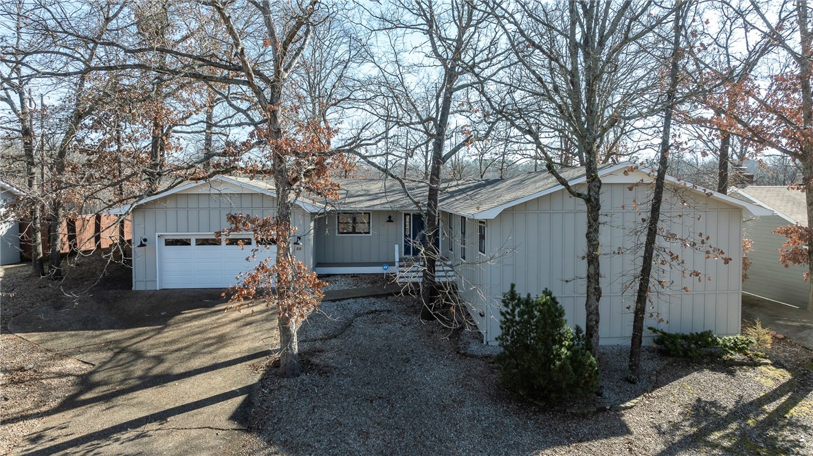 Prime Location! This beautifully updated home offers immediate access to the popular Tunnel Vision Mountain Bike Trail, a short walk to Lake Windsor, and is just minutes from all the amenities Bella Vista has to offer. The home features 3 spacious bedrooms, each with its own private bath, plus a dedicated Office/Library with custom built-in shelving. Updates throughout include new flooring, fresh paint, new appliances, modern fixtures and vanities, stylish new tile showers, new AC/Heat pump, and newer roof (2021). The home is on a 2-bedroom septic system. Enjoy the open-concept layout with a sun-filled eat-in kitchen and a cozy sunroom that invites relaxation. Step outside to the generous, private deck - perfect for entertaining or simply unwinding in your own outdoor haven. The backyard is FLAT and has a brand-new fence, but we aren’t bragging :). This home embodies all things Bella Vista. Schedule your showing today!