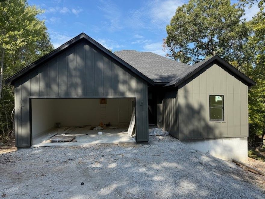 ***$5,000 buyer concession when using our preferred lender!*** This beautifully built 3-bed, 2-bath home offers modern comfort and thoughtful design. Step inside to find LVP flooring throughout the main living areas, with tile in both bathrooms for a sleek, easy-care finish. Each bathroom features a tiled shower, while the kitchen shines with quartz countertops, stainless fixtures, and plenty of cabinetry for storage. The open-concept layout creates a seamless flow between the kitchen, dining, and living spaces—perfect for entertaining or relaxed everyday living. Enjoy the wooded surroundings from the freshly built back deck, ideal for morning coffee or gatherings. Conveniently located just minutes from the interstate, this home offers quick access to shopping, restaurants, and all that NWA has to offer, while still providing the privacy and natural charm Bella Vista is known for. With its quality finishes, modern craftsmanship, and unbeatable location, this new construction is ready to welcome you home.