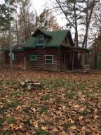 Owner is wanting to Sell! He has dropped the Price! On this all wooded 40 acre tract with a cabin style home. Garage, drilled well, lots of privacy and wildlife, This would make a great hunting tract!