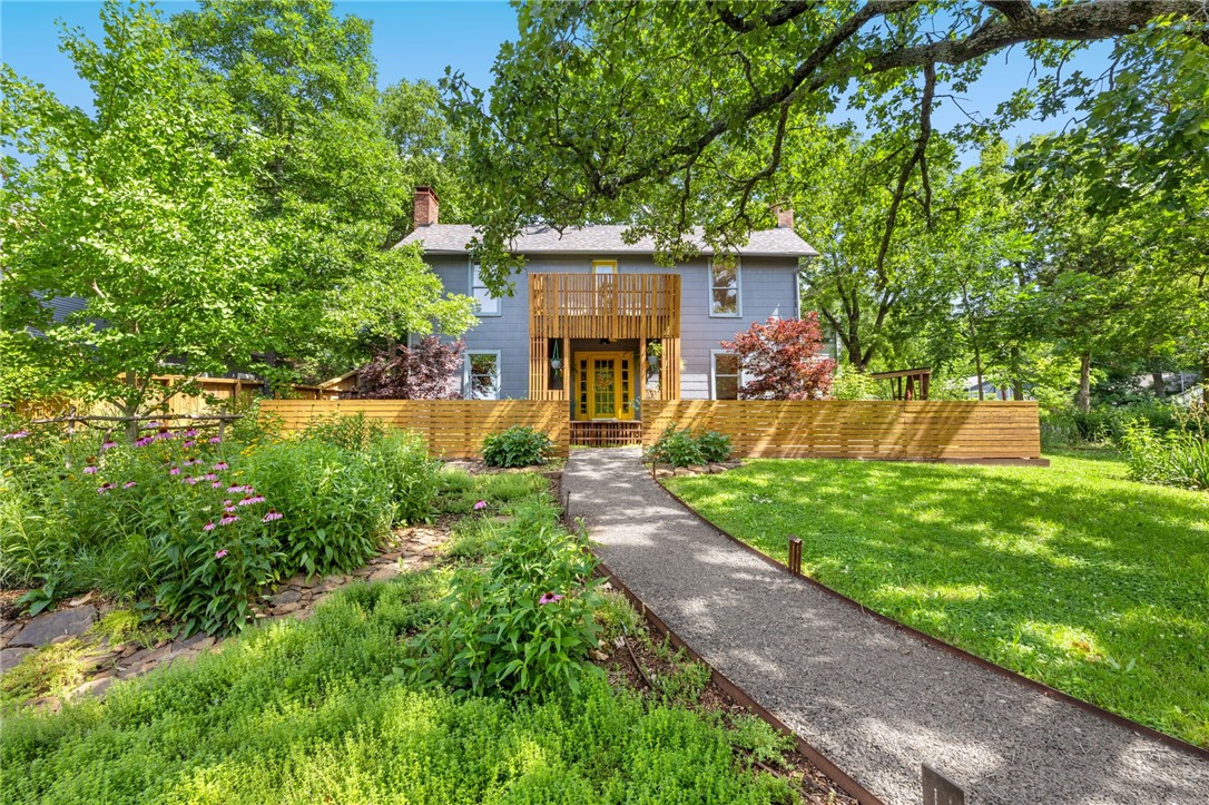 Don't miss this rare opportunity to own an architecturally significant home in the coveted Historic District of Fayetteville. This stunning home & garden, a landmark within the neighborhood, has been meticulously maintained & extensively updated in recent years. It boasts 3 spacious bedrooms, 2.5 modern bathrooms, a cozy library, an inviting living room, a formal dining room, a fully-renovated kitchen, and dry bar all showcasing original hardwood floors and exquisite millwork.
Perched atop a generous corner lot, the property is landscaped w/ native perennial flowers, grasses & trees. Outdoor living is enhanced by professionally designed & installed features such as a contemporary courtyard, deck, porch & covered walkway.
Spot zoned RSF-8, the property offers flexibility for accessory dwellings a lot split to add an additional home. The extensive updates are too numerous to list here, so contact your local real estate professional for a comprehensive overview of the upgrades & amenities. Call today for a tour!