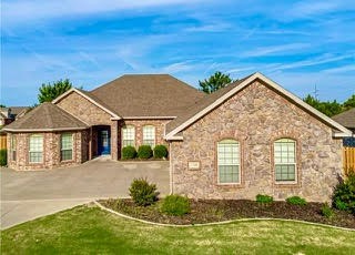 Location, location, location! Fall in love with this beautiful home in Riverwalk Farm Estates, just a scenic walk from Osage Creek Elementary. This 3-bed, 2.5-bath home features a spacious 3-car garage, crown molding, and hand-scraped hardwood floors. With two primary bedrooms, it’s perfect for flexible living. The kitchen includes built-in appliances, an oven/microwave, and exotic granite countertops. Enjoy natural light in the living room and cozy meals in the dining area. Step outside to a covered patio and extended pergola—ideal for entertaining or relaxing evenings. The Riverwalk community offers a park, pool, trails, and is close to the Bentonville Community Center, schools, and shopping. Don’t miss this opportunity—schedule your showing today!