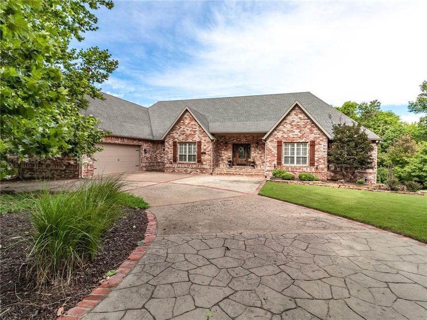 Pristine Home on 1.15 acres NEAR the UofA, Interior finishes include hand scraped hard wood floors throughout the main level with newly carpeted secondary bedrooms, staircases and upstairs bonus room.  Plantation shutters throughout, Stainless Steel GE Monogram and Bosch appliances in both main level and downstair kitchens, theatre room with surround sound &  8 leather reclining seats, decorative trey ceilings, wainscoting, crown molding, granite countertops,  and more.  Master bedroom includes two separate spaces for office, nursery, sitting or craft rooms.   The  garage is 33ft x 21ft with a storage room.  Beautiful sunsets can be viewed from the back deck or hot tub that conveys with the home.  Includes one year Seller Home Warranty.