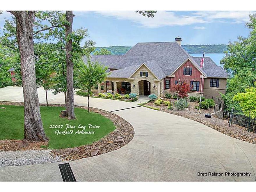 Exquisite custom built lakefront home with every custom feature you would want if building your own!  The grounds include 3 acres with breathtaking views and a 4 slip boat dock.  Two outdoor living spaces with wood burning fireplaces.,Amenities include;  hardwoods and tile throughout home, gourmet chef's kitchen, crown moldings, handicap accessibility, elevator ,ample storage, 4 car garage and 4 car workshop/garage, automatic generator.  See attachment for a complete list.