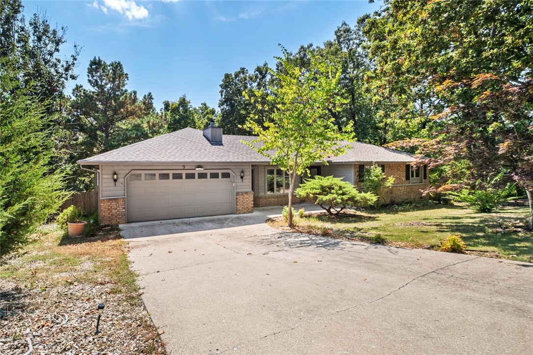 A fantastic family home awaits you or buy completely furnished and use as an Airbnb! As you open the front door you are greeted by new flooring throughout with upgraded carpet padding to make walking feel like walking on air. The spacious living room has an area for a small office space and a cozy fireplace for those chilly Arkansas nights. The kitchen has been completely updated and made over with a wall taken out to open up the space to a 30 foot sprawling sunroom overlooking the backyard. Primary bedroom has an ensuite and large walk-in-closet. Two more good sized bedrooms and a bathroom wrap up the interior of this home. A two tiered deck is out back allows plenty of space to relax and watch the kids or pets play in the fenced backyard. If you like to tinker there is a huge 250 square foot outbuilding in backyard with electricity you can use for all your projects. Home can be purchased fully furnished to use as a second home or Airbnb. Close to the trails, golf, and lakes of Bella Vista.