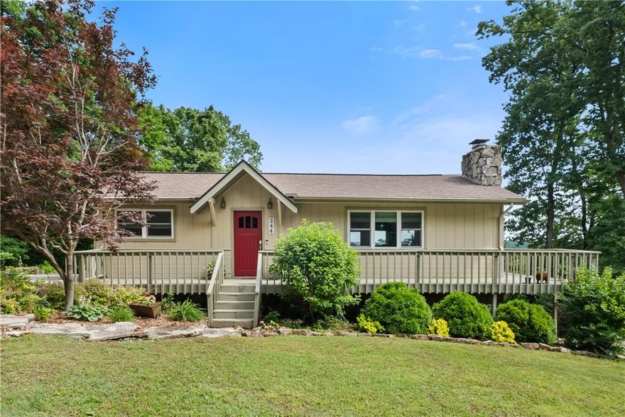 Enjoy stunning views of the Ozarks for miles from the back deck of this beautifully remodeled home. The front door opens into a spacious living room with cathedral ceilings, wood floors and a wood-burning fireplace made of native stone.  The dining room boasts mountain views and a glass door that opens onto the back deck - perfect for entertaining.  The kitchen has custom cherry cabinets, native limestone counters and a pantry. The ensuite bedroom and bath has a jetted tub and a tiled shower. A guest bath completes the main floor. The lower level has a sitting area, two guest bedrooms and a full bath. French doors in two rooms open onto the lower back deck. A workshop and greenhouse provide the perfect spots to pursue your hobbies. Holiday Island, with its two golf courses, tennis, swimming pool, and marina, offers a variety of recreational activities. A short drive to downtown Eureka Springs, Roaring River State Park, Dogwood Canyon Nature Park and Branson, ensures there's always something exciting to do.