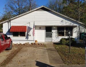 If you are looking for a cozy home located in Russellville without a huge price tag, this is it!! This 1294 sq foot rustic style home features a nice sized, remodeled living room with a beautiful handmade pseudo fireplace, spacious dining room, two bedrooms, an updated kitchen and 1.5 baths. Outside there is a large deck for entertaining, a new firepit, and a 10 x 11 storage building built on a slab with electricity. Your fur babies can exit the house thru the pet door and enter the back yard that is fenced, (in addition to an electric barrier fence), and have a safe area to play in. There's also a large fenced enclosed/pen for pets in the backyard. New paint throughout. Roof is less than 7 years old.