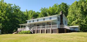 Tucked Away in Private Setting on 84 Acres along Little Red River you'll find this outstanding 4,850 sq ft home, main level features 2 living areas each with massive native stone fireplace, open kitchen and dining area, large master bedroom, office, and extra bedroom. 2nd floor has balcony and 2 oversized bedrooms with Jack-and-Jill bath, several European stained glass windows throughout, HVAC with 3 units to adjust for comfort zones, oversized attached 2 car garage, partially covered wrap around porch, and serviced by spring water. The land has about 30 acres of bottoms for cattle, horses, or hay along the middle fork of Little Red River, a 24x72 equipment shed with concrete floor and attached work shop, 28x60 pole barn, and an old log barn that dates back many years.
