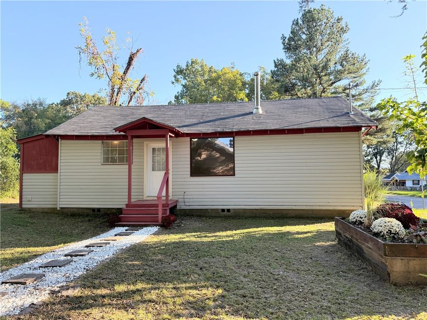 Completely remodeled three-bedroom, two-bath home situated on a corner lot. This property features beautiful hardwood flooring in the spacious living room accented by a cozy fireplace. The interior offers fresh paint throughout, new kitchen cabinets, and a new roof. Move-in ready and thoughtfully updated, this home combines charm, comfort, and convenience.