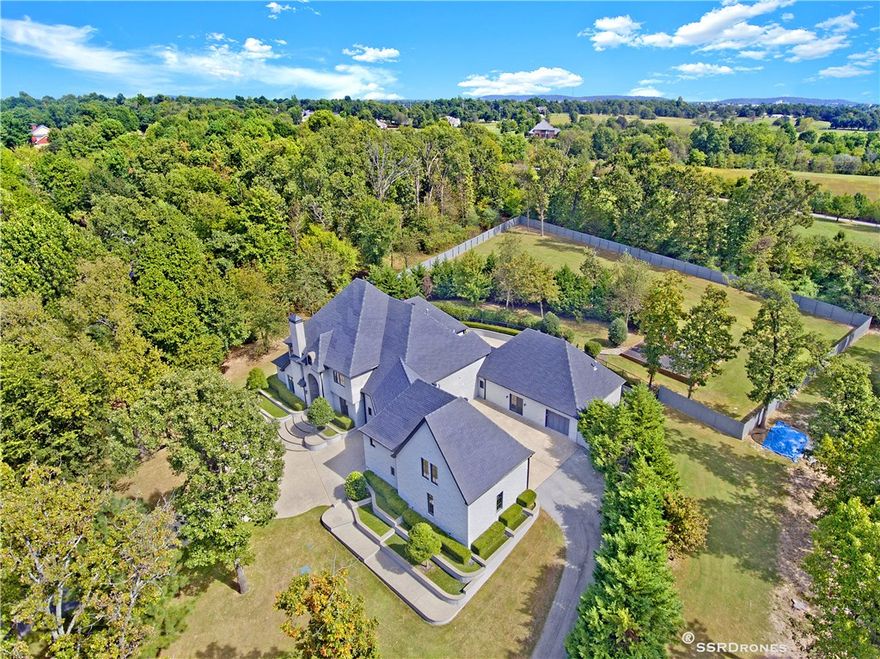 Incredible property in the heart of Springdale off Don Tyson Express Way. This gorgeous estate sits on
almost 3 acres. You will love the sophisticated metropolitan style and high end finishes. Originally built by
Celtic Construction. All bedroom have ensuites including a steam shower in the master bath. The bonus
room has a private entrances and ensuite bath also. Large theater room on main level. Enjoy the heated
splash pool with built-in hot tub year round. The grounds are well manicured.