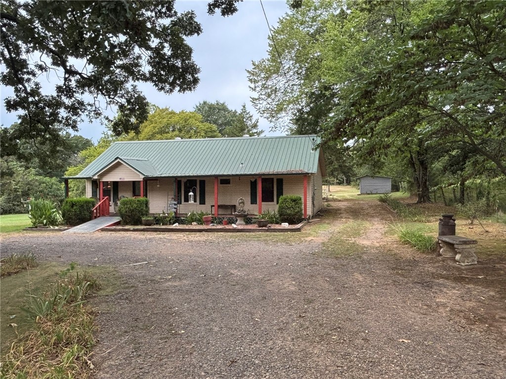 Charming country home just outside of Dardanelle, with NO restrictions. The perfect landscape to create your own hobby farm. Beautifully maintained 1.36 acres only minutes from town. The home is very inviting with 3 bed rooms and two full baths. A warm living space and open dine in kitchen. Lots of updates with new flooring. Outside you will find everything you need from small scale farming, gardening or raising animals. Enjoy the bounty of your own place with producing fruit trees. A large shop sits at the back of the property providing ample space for equipment. Quiet, private and ready to be made yours.