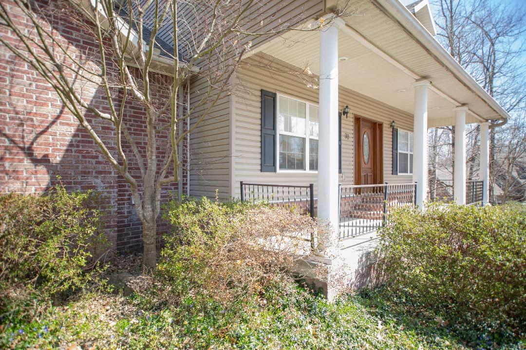 Curb appeal at it's best! Spacious home on a corner lot that includes an adjacent property. The kitchen has granite countertops, ample storage cabinets, and a large pantry. Upstairs contains three bedrooms and two full baths. Large Master Suite contains a sizable walk-in closet and has back deck access. Master bath features a double vanity and whirlpool tub. Downstairs features three spacious rooms, full bath with double vanity, and central family room with wet bar containing a mini-fridge and sink. he 3rd car garage downstairs is heated and cooled to be used as a workshop if desired - great for parking your golf cart. Both garages have fully insulated garage doors that help keep them warmer in the winter months and cooler during the summer. It also contains an upgraded central heating and air system, central vacuum, and outdoor sprinklers. The roof was newly replaced in the Fall of 2019.