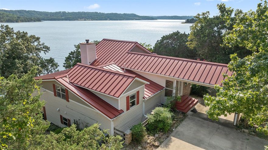 Experience the best of lakeside living with this 3 bed, 3 bath, 3175 sqft home on Beaver Lake, just minutes from Rocky Branch Marina.  With a property line that extends to the water's edge, this unique property is perfectly positioned to offer breathtaking panoramic views of Beaver Lake.  Inside, a light-filled living room showcases expansive lakefront windows.  The recently remodeled kitchen features quartz countertops and modern finishes, while the updated bathroom adds a touch of luxury.  Upstairs, a spacious flex room serves perfectly as a home office or easily converts into a 4th bedroom.  Additional highlights include a new HVAC system, a metal roof, a 24x21 covered deck ideal for entertiaining, and a detached 30x20 garage with ample storage for your lake toys.  Enjoy direct lake access with your own private boat/PWC lift just step from the home.