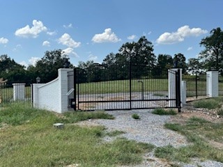 6.74 acres of your own private oasis. Pre-perked for a 7 bedroom home. Developers take note or buyers looking for a out of city limits piece of Bentonville. Private security gate already installed with private solid walled fence along side and bottom, vertical wrought iron with brick pillars and solar lights at the top part and paved asphalt access road. entire property has been manicured to where a zero turn mower can be used to keep the property in pristine shape. No brush hog needed.