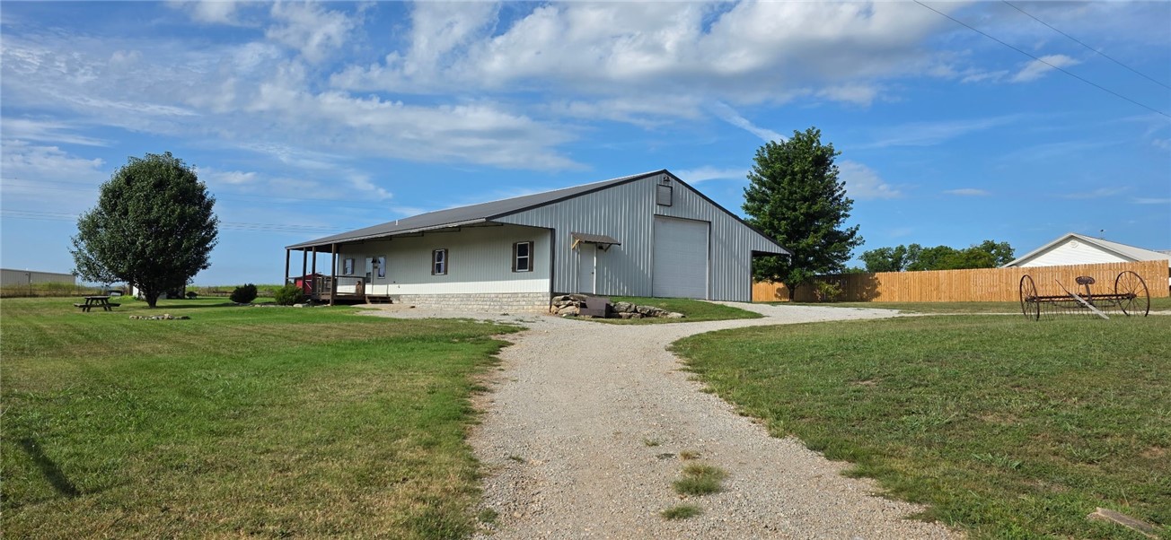 Enjoy country living in this beautiful two-story home located in the desirable Meadows Subdivision, just minutes from downtown Berryville. Nestled on 5+ acres, this low-maintenance property features a metal roof with metal siding. Step inside to an inviting open-concept featuring radiant-heated stained concrete floors, spacious living and dining area. The gourmet kitchen showcases rich cherry cabinetry, stainless steel appliances w/ample counter spaceāideal for entertaining. The primary suite offers privacy w/an ensuite bath and lrg walk-in closet. 1/2 bath is located just off the dining area. An oversized lndry/mudroom connects directly to the garage/shop. Upstairs, you'll find two generously sized bedrooms and a full bathroom. The 40x40 insulated shop/garage has foam insulation, built-in workbenches, automatic garage door. Utilities incl. rural water and septic system. Whether you're looking for a peaceful retreat or functional home w room to grow, this property captures the essence of Ozark living at its finest.