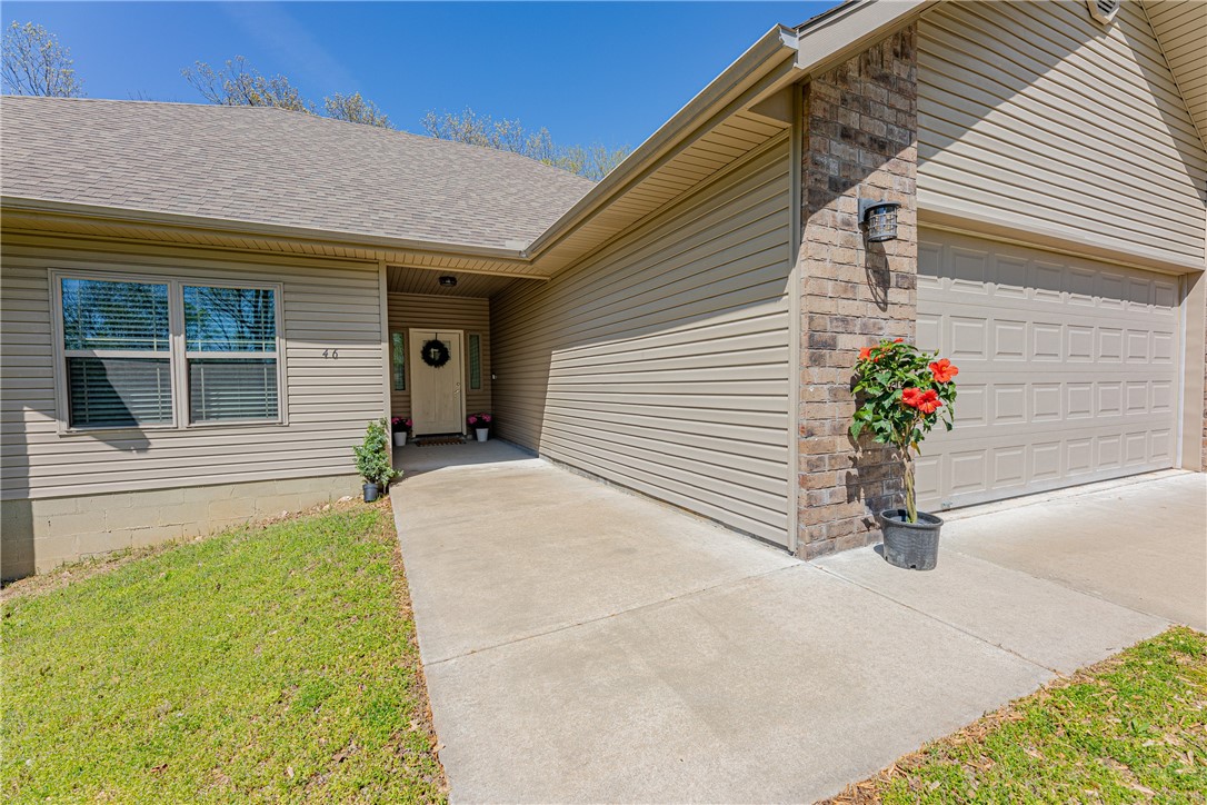 This immaculate home offers modern living at its finest. Newly constructed in 2019. Step inside to discover an inviting open floor plan, highlighted by a spacious living room boasting a soaring vaulted ceiling. The well-appointed kitchen features sleek stainless appliances, including desirable propane range and oven-a dream for any home chef.
The home flows beautifully with engineered floors and carpet in bedrooms. Enjoy the privacy of a split floor plan, featuring two full-size bathrooms with a tub.
Extend your living outdoors to the expansive covered deck, an ideal spot for relaxation or entertaining while overlooking the large private backyard and tranquil wooded area. Benefit from public sewer, Bentonville school district, and easy access to the highway for effortless commuting. This gem won't last long.