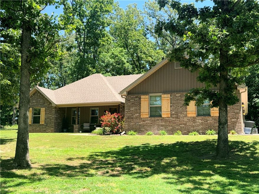 1.26 sprawling acres in the idyllic rolling hills of Madison County,AR,this is a retreat just shy of 2,000 SF.It has the flawless condition of a new home (but it's not),updated with fresh int. paint, new carpet in the BR's,new wood laminate flooring in the primary.Double vanities in the primary bath,with a jetted tub,W/I shower and a spacious W/I closet.The chef-ready kitchen is designed for easy entertaining showcasing granite,island, SS appliances,gas range & under-counter lighting.The LR invites coziness with a gas log FP flanked by custom built-ins. You'll also find newly installed light fixtures in all bathrooms & plentiful storage.Outside, the circle drive provides ample parking while the private,wooded setting offers unparalleled serenity.Enjoy the cool breeze & the shade of mature oak trees,or retreat to the screened-in patio area.This peaceful haven is ideally situated,offering an easy 35-min commute to Fayetteville and just 40 min to Eureka Springs & the outdoor adventures of the Buffalo River and Hiking.
