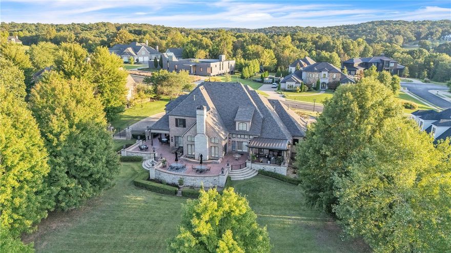 The crown jewel of Northwest Arkansas golf course living, now offered for sale. An unparalleled opportunity to own one of the most coveted golf course estates in Northwest Arkansas. This European French–inspired residence blends elegance with comfort on a stunning golf course lot behind the private gates of Clear Creek. Inside, the main level features a stately office and a spa-like primary suite. With 4 bedrooms, 4.5 baths, & two levels of living, the home balances private retreats with grand entertaining spaces. The chef’s kitchen boasts a Sub-Zero refrigerator, new 8-burner cooktop, marble island, and wine storage. Upstairs, a media room with custom bar & theater offers the ideal gathering space. Outdoors, a wraparound brick patio overlooks The Blessings practice green & bunker—feels like your private “Amen Corner.” Lush landscaping creates a serene setting. I-49 minutes away. 5498 Clear Creek, where privacy, prestige & luxury meet. Home generator. New Roof, New HVAC 2025. Meticulously maintained inside and out.