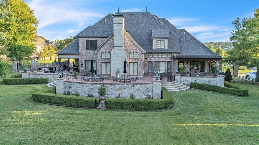 The crown jewel of Northwest Arkansas golf course living, now offered for sale. An unparalleled opportunity to own one of the most coveted golf course estates in Northwest Arkansas. This European French–inspired residence blends elegance with comfort on a stunning golf course lot behind the private gates of Clear Creek. Inside, the main level features a stately office and a spa-like primary suite. With 4 bedrooms, 4.5 baths, & two levels of living, the home balances private retreats with grand entertaining spaces. The chef’s kitchen boasts a Sub-Zero refrigerator, new 8-burner cooktop, marble island, and wine storage. Upstairs, a media room with custom bar & theater offers the ideal gathering space. Outdoors, a wraparound brick patio overlooks The Blessings practice green & bunker—feels like your private “Amen Corner.” Lush landscaping creates a serene setting. I-49 minutes away. 5498 Clear Creek, where privacy, prestige & luxury meet. Home generator. New Roof, New HVAC 2025. Meticulously maintained inside and out.