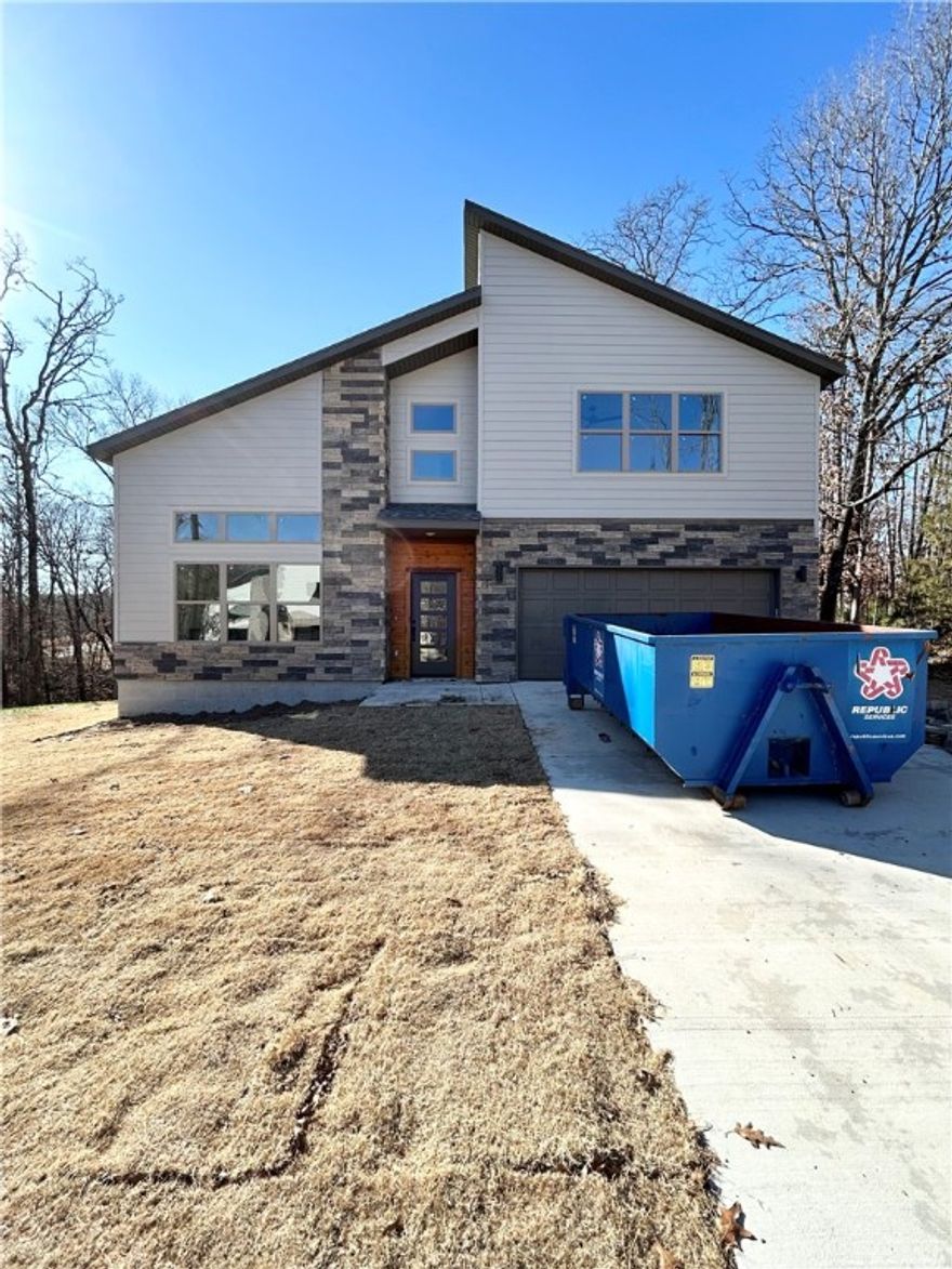 Modern new construction on a .36-acre wooded cul-de-sac lot! 2 bedrooms / 2.5 baths + office. Step into a bright and airy interior featuring tall ceilings and a striking 2-story linear fireplace. The kitchen includes custom cabinets, floating shelves, gas range, and 3 cm quartz countertops. The primary bath features a soaking tub and a walk-in tile shower. Enjoy abundant natural light throughout, and entertain on the spacious deck overlooking the serene landscape. High-end finishes throughout. Located just minutes from the Branchwood Recreation Center and Lake Loch Lomond. As an added bonus, receive $3,500 towards buyer's closing costs when working with the builder’s preferred local lender!