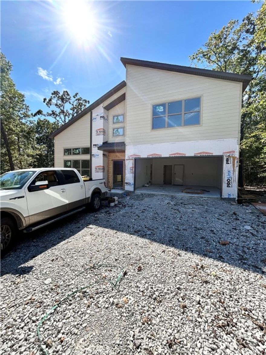 Modern new construction on a .36-acre wooded cul-de-sac lot! 2 bedrooms / 2.5 baths + office. Step into a bright and airy interior featuring tall ceilings and a striking 2-story linear fireplace. The kitchen includes custom cabinets, floating shelves, gas range, and 3 cm quartz countertops. The primary bath features a soaking tub and a walk-in tile shower. Enjoy abundant natural light throughout, and entertain on the spacious deck overlooking the serene landscape. High-end finishes throughout. Located just minutes from the Branchwood Recreation Center and Lake Loch Lomond. As an added bonus, receive $3,500 towards buyer's closing costs when working with the builder’s preferred local lender!