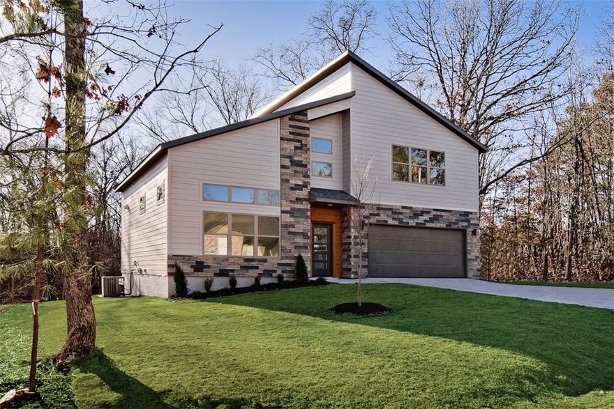 Modern new construction on a .36-acre wooded cul-de-sac lot! 2 bedrooms / 2.5 baths + office. Step into a bright and airy interior featuring tall ceilings and a striking 2-story linear fireplace. The kitchen includes custom cabinets, floating shelves, gas range, and 3 cm quartz countertops. The primary bath features a soaking tub and a walk-in tile shower. Enjoy abundant natural light throughout, and entertain on the spacious deck overlooking the serene landscape. High-end finishes throughout. Located just minutes from the Branchwood Recreation Center and Lake Loch Lomond. As an added bonus, receive $3,500 towards buyer's closing costs when working with the builder’s preferred local lender!