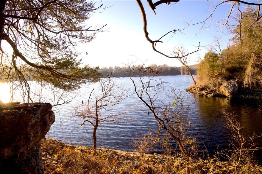 Rare 66± acre tract in Oaks Landing offering privacy, panoramic views, wildlife, and future development potential. Featuring nearly 1,500 ft of Corps of Engineers frontage on Table Rock Lake, this property combines size, affordability, and direct lake proximity. Located at the end of a quiet road, it offers a private, nature-preserve feel with hardwoods, cedar thickets, rock features, and an existing trail system. A stunning hardwood knoll sits approx. 320 ft above the lake, providing an exceptional and private estate-caliber building site with lake views. Enjoy peaceful kayak access or excellent fishing along the shoreline. The land also includes a spring and diverse habitat throughout. As the only remaining subdividable lot in Oaks Landing, it offers strong investment value. Oaks Landing is a secluded 45-lot community with mostly paved roads, peaceful setting, and a resident-owned swim/fish dock, located just 30 minutes from Eureka Springs and less than an hour from Branson and  the NWA metro!