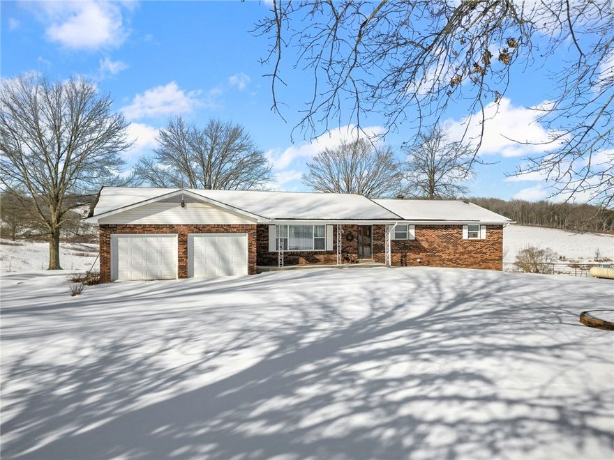 Offered at a new price. Day on market may reflect previous listing history in accordance with MLS Rules (1/29/26). Private and peaceful 3-bedroom, 2-bath brick home with stunning views. Features include a walk-out basement, expansive flat yard, large barn, covered back deck, and covered patios—perfect for outdoor living and entertaining. No neighbors within roughly 1/5 mile for ultimate privacy.