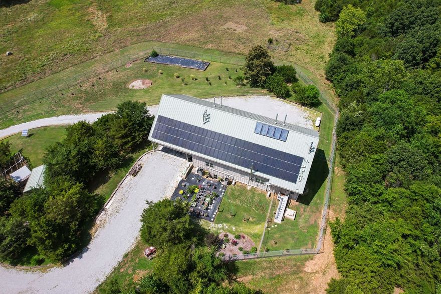 DISCOVER THE ULTIMATE in self sufficiency and security with this exceptional 30.91 acre homestead featuring state of the art underground survival bunker.  Nestled in the tranquil hills of the Ozarks, this property offers unparalleled opportunity to live completely off grid.  19,000 Kilowatt Solar power system (EMP Protected), 6 Outback inverters, 5 Midnight solar charge controllers, 120+ roof panels & new (2023) battery bank. 300+-sf underground shelter w/HEPA filtration & 1/2 bath.   3 water sources; rural, windmill powered well, rainwater collection system w/underground storage including 8- 2000gallon rainwater collection tanks.   Fully operational windmill, Rustic Barn, .7 acres zoned/approved for cemetery.   Two natural springs reside on this picturesque property along with two gardens, chicken coup, Honeycrisp apple, pear and 10 peach trees.   Diesel generator 3000gal tank
Three levels: Main level 3304sf  2nd Floor 2824sf and Finished Basement 2173sf.  
Home is plumbed for radiant heat.   Quality and Divine