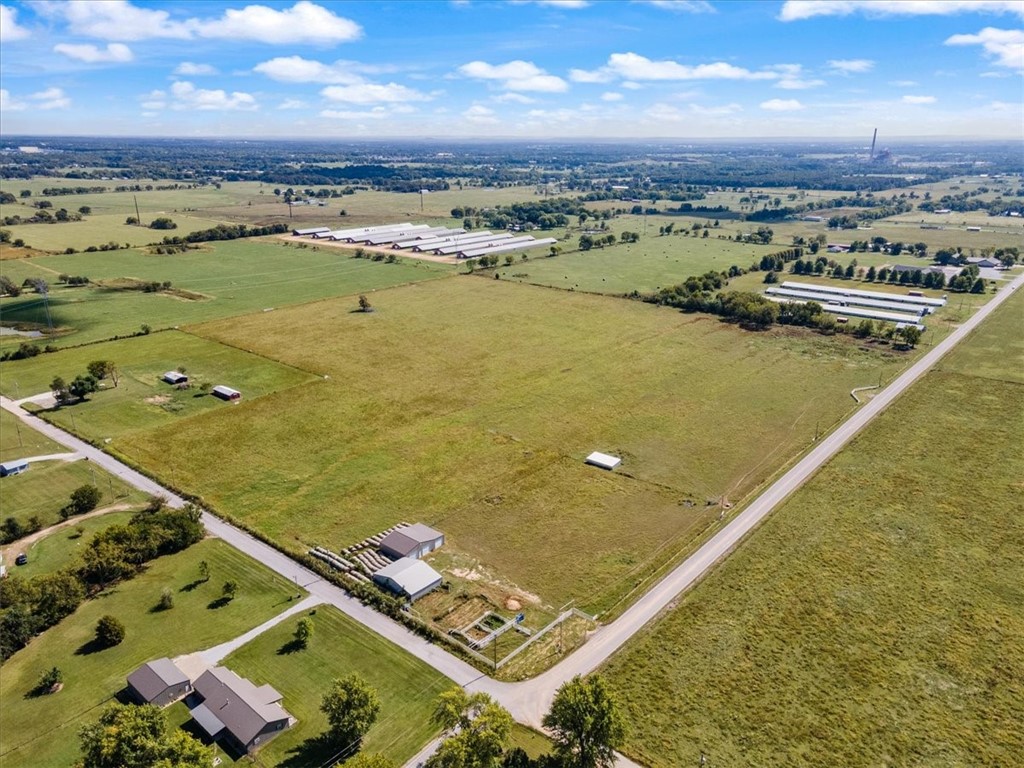 Large 34.91+/- acre of flat level land available. The owner will subdivide and sell 28 acres of pasture land only for $25,000 per acre $700,000. Please see MLS # 1269707. Approx. 3.9 miles NW of Gentry city limits. Great property for developing with 1342 ft. of road frontage on Bloomfield N Rd. and 792’ road frontage on Floyd Moore Rd. Property located in Gentry schools’ district. Water & electric at the street as well on the property. Two buildings on the property 42’ x 50’ equipment barn with a 12’ x 50’ lean-to attached and 66’ x 50’ workshop on a slab, equipped with 2 hydraulic lifts and (3) 12’ doors for large equipment.