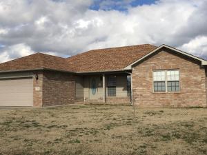 This is a must see, 3 BR/ 2 Bath home and is a great open floor plan . It has beautiful wood flooring in living room,halls,and bedrooms. Large kitchen and dining space are tiled and lead to a charming covered porch. Utility room has sink,window,and extra cabinets. Large storage building in back yard . This home also has a storm shelter in the garage. This will move quickly don't wait call today!