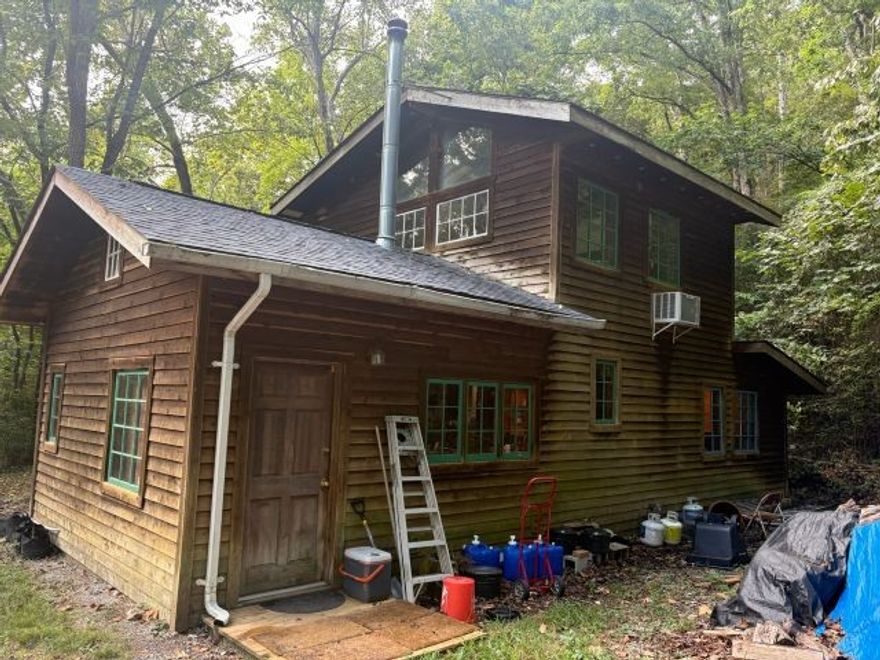 Escape to your own slice of nature with this charming 11.34-acre property featuring two homes, a year-round creek, and a natural spring. Surrounded by mature woods, this private setting offers peace, seclusion and abundant wildlife. Main home includes 1 bed/1 bath perfect for cozy living. A second 1 bed/1bath guest house provides space for family, visitors, or potential rental income. Whether you're looking for a full-time residence, vacation retreat, or income property, this peaceful woodland sanctuary is ready to welcome you.