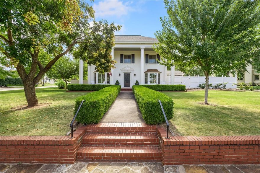 The landmark corner of Washington Avenue and Lafayette in historic Fayetteville showcases this
absolutely stunning, full brick, 1937 Greek Revival estate. The large corner lot with off-street parking on a
private driveway is a rare find among properties in the Washington-Willow district. The main level includes
two living areas with gas-long fireplaces, an updated, eat-in kitchen, dining room, half bath, and
separately heated/cooled sunroom. Four bedrooms with ensuite bathrooms are upstairs, along with one of
two laundry rooms. The two largest bedrooms have gas-log burning fireplaces, and all bedrooms have oak
hardwood floors. The finished basement level with its own private exterior entrance offers a second
laundry room, half bath, work-room, and two large rooms that could be many uses. A 1940's well still
exists in the bottom level of the home. To truly appreciate the character and beauty of this well appointed
historic home you simply must see it in person.