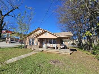 Rock building with carport, adjoins commercial property, Dodger Store. Would be a good location for business, medical, or multiple uses.