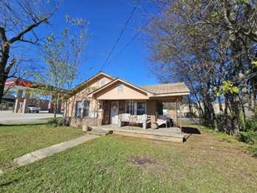 Rock building with carport, adjoins commercial property, Dodger Store.  Would be a good location for business, medical, or multiple uses.