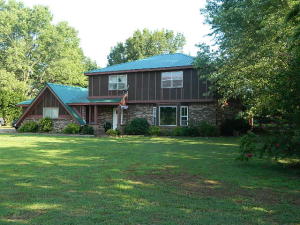 This Large family home is ready for yours. It features 3 baths, living room and den, mother in laws quarters, updated kitchen, glassed in room with built ins, fireplace, French doors opening out to a kids dream of a back yard, complete with covered patio. The home sets on 1.75 acres inside the city limits on a park like setting. Priced below market value, hurry call now to see.