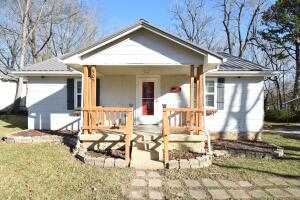 This cute little house is perfect for a first time home buyer or a family wanting to downsize into a smaller home!! The metal roof was put on about 2 years ago, updated flooring throughout most of the home, updated plumbing and electrical. Large outbuilding with electric and double lofts for extra storage. Home has a Night Owl surveillance system installed. A double lot makes for a large backyard for the kids or grandkids to play. Don't miss out on this charming home.