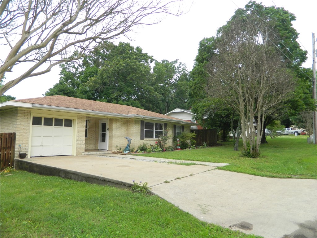 Wonderful new listing on BIG corner lot. Wired to work from home with CAT 5 internet and 3rd bedroom has "pocket" doors so very stylish look if used as an Office. Double paned vinyl windows throughout, new microwave, freshly painted and wood floors recently added, utility area recently enclosed and is has heat and air. BONUS!! Fabulous 20 x 16 Foot detached work space with full bathroom!! Could be mother-in-law living area or great she-shed!!. Is on separate electrical box - and has instant hot water!! The green house and metal shop building in back yard are to be moved but could be negotiated (along with furniture in detached building) - but are NOT included in listing price. Wood privacy fence around full backyard.Home Owner's Warranty provided!