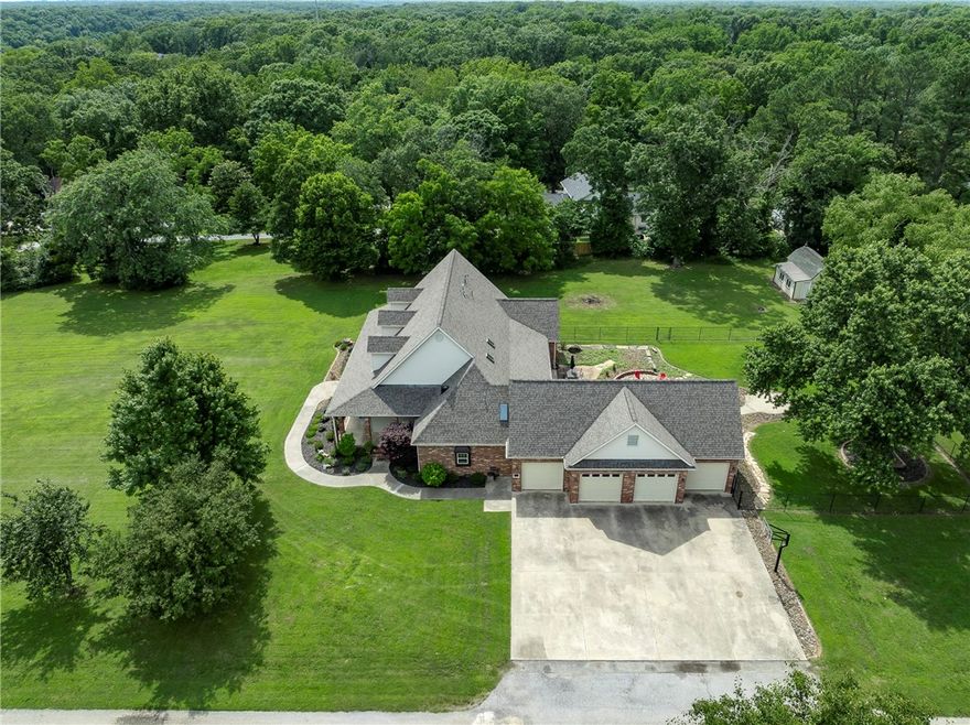 Looking for a home that is the best of all worlds? Pull out that list and just check all the boxes right now. Spacious, quality home, check. 4 car garage plus detached shop, check. Acreage and elbow room, check. Close to DT Rogers and an easy drive to Bville, check. You'll see why falling in love with this home is inevitable! The massive front porch just invites friendly conversations, morning coffee sitting and opens the door into the immaculate interior with plank oak floors, built-ins and a functional layout sure to please the most thoughtful homeowner. 5 bedrooms plus an office and 4.5 baths give space for everyone, including a studio apt layout over the garage that could be great for teens, guests or rental income! This home is like a gold mine with hardwood trim and details throughout and lots of updates to make this classic country home the place all your friends will love to visit and you won't want to leave! Don't miss the 3D tour and then come see this masterpiece for yourself! No HOA, 3yo roof.