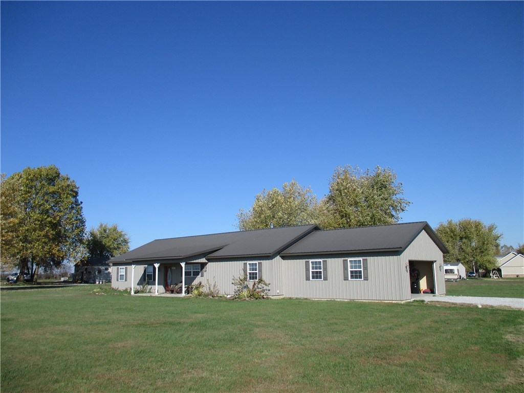 2006 four bedroom, 2 bath "like new" 1920 sf home on a 3 acre corner lot. Home is in great condition with 2 car attached garage, fenced on 2 sides with public water! Storm shelter just off back deck with a large covered front porch, country, ranch style setting! Convenient to town!