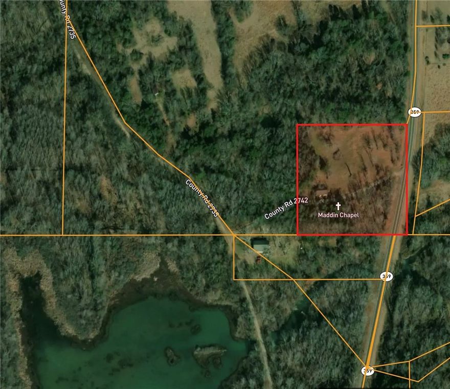 This lot was sold prior to being on MLS. 4 Acres with an old church building on the 4 acres that is split by the county road. Back waters of Piney Bay Lake area.