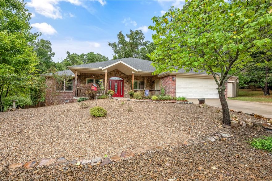Welcome to this spacious 3-bedroom, 2-bath home in the desirable Buckingham subdivision, steps from Buckingham Trailhead. Offering 2,618 sq ft, this property blends comfort, style, and outdoor fun. The main level features an open living room with soaring ceilings, gas-log fireplace, formal dining area, and built-in details The kitchen has granite counters, pantry, and glass cooktop, . The split floor plan includes a XL primary suite with whirlpool tub, walk-in shower, and generous closet space. Two additional bedrooms and a full bath complete the main floor. The updated basement offers a bonus/media room  space, perfect for entertainment or hobbies. Accessibility features include wide doorways, that are wheelchair access. Enjoy outdoor living with a screened porch, huge deck, & fenced backyard. Community amenities - trails, pools tennis, playground, and clubhouse. Zoned for  Bentonville schools. Additional side lot dedicated to this home provides added privacy and space wi/out extra cost. New paint/new flooring.