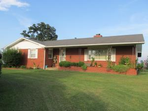 10 Acre Ranchette with Nice Home, Great Views & Paved Road Frontage! Fireplace, hardwood floors, updated kitchen. Outbuildings include well house, 12 x 27 ft storage bldg and work area, 36 x 30 ft 3 stall pole shed, 2 year old Trane central heat/air, roof approx 6 yrs old, good garden spot, fruit trees, pasture, lots of paved road frontage, city water inside and good well water outside.