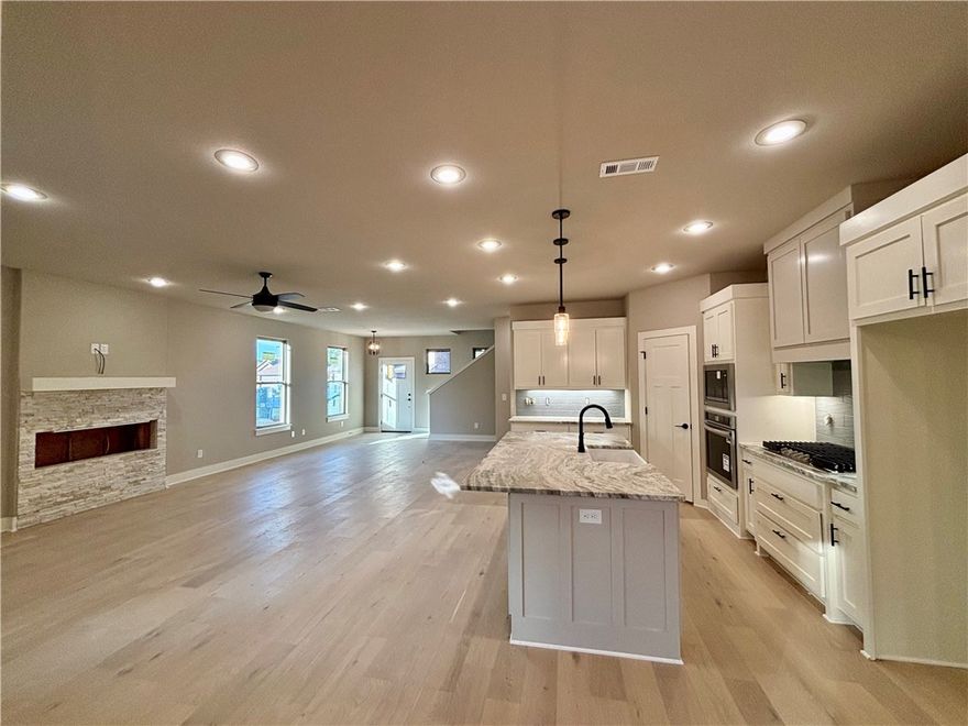 Exceptional new construction in the heart of booming Pea Ridge. This 4-bedroom, 3.5-bath residence showcases elevated craftsmanship and a modern design. Crafted with attention to detail, this home highlights a linear fireplace, LED lighting, and elegant finishes throughout. The split floor plan includes two primary suites, offering flexibility. The kitchen is a showpiece with granite countertops, quality cabinetry, and a seamless flow ideal for entertaining. Thoughtful touches continue with walk-in closets, ample attic storage, and a brick-and-vinyl exterior that blends style with lasting durability. Set in one of Northwest Arkansas’s fastest-growing areas, this home combines modern luxury with everyday comfort — a truly standout property in Pea Ridge.