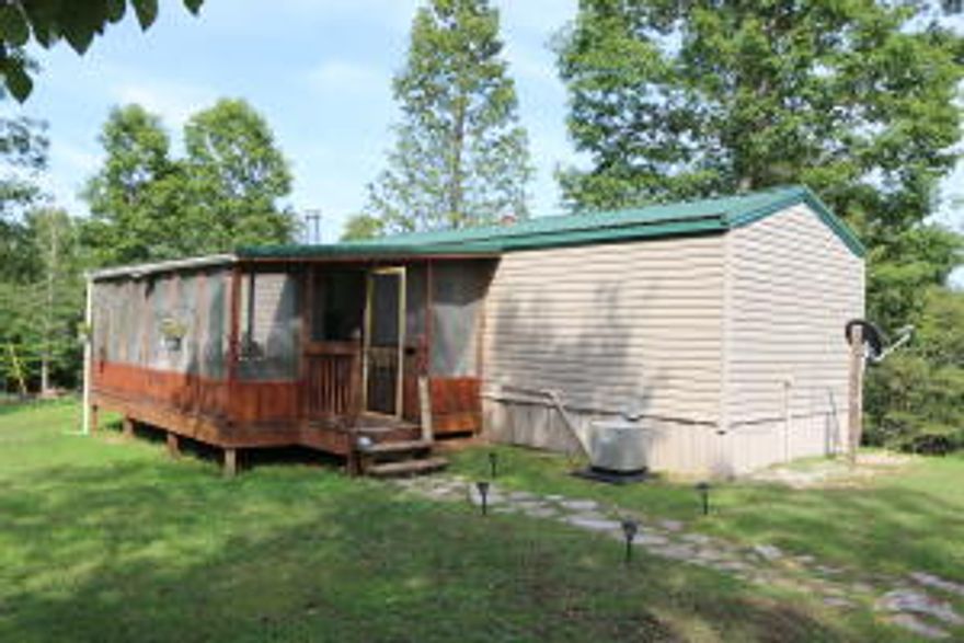 The Ozarks are world famous for its flora, fauna and vistas. These 40 acres +/- have it all. Check the photos and you will see a stream, hilltop view, shady trails through a secluded valley. In addition, there are trophy white tail deer, wild turkey and feral pigs for the hunters. A ''neat as a pin'' manufactured home and a detached 2 car garage are on the property located just off the pavement. You owe it to yourself to at least come see this little piece of heaven on earth but hurry because it won't last long.. Need 24 hour notice before showing. GPS location 36.082114, -92.729133