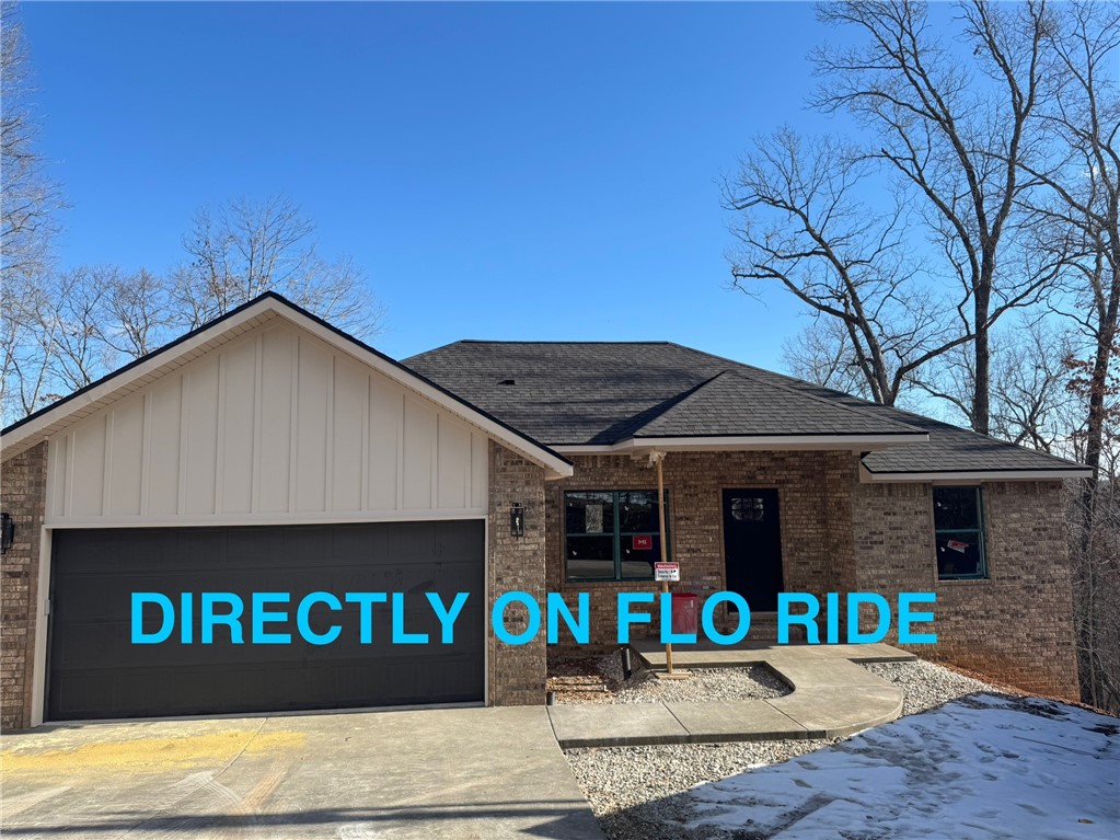 Are you a BIKE enthusiast? This NEW construction home sits directly off The Back Forty on the FLO RIDE trail. When looking out towards the backyard, look towards the left to find the trail (marked with PINK flag). This 3 bed, 2 bath home has an open main living space with gorgeous soft green custom cabinets, quartz countertops, large pantry with barn door to match the cabinets & room on the island for stools, and dining space. LVP flooring thru out the entire home for ease of cleaning as well as a seamless look. Split floor plan with the main bedroom has a custom wood feature wall, roomy walk-in closet, ensuite bath with tile shower & dual vanity. On the other side are 2 bedrooms, bathroom, linen closet & closet for additional storage space. Mins away from Lake Ann & about 6 miles to Metfield area which boasts access to the Greenway (road bike riding), golfing, pickleball courts, playground, bike skills park, gym, clubhouse & pool. BENTONVILLE SCHOOLS! Stairs off deck coming soon! 2K CONCESSIONS OFFERED
