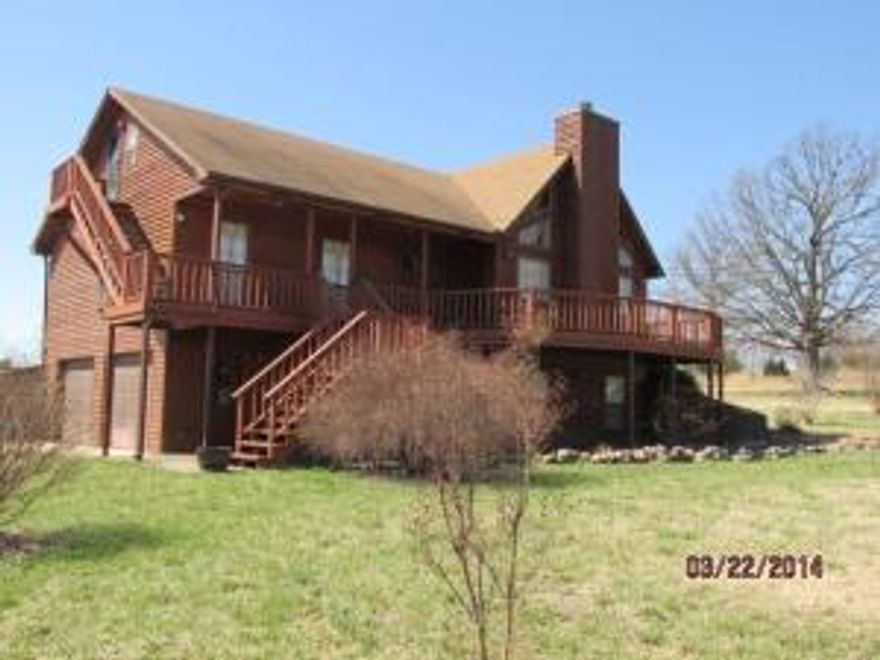 Great home near the lake, Mt views in the back & only 4 mi to Tucker Hollow Marina.Newer Cypress hardwood floors in the living room & stairway, LR has stone fireplace, & vaulted ceilings w/exposed beams.Kitchen open to LR. Almost 1400' of deck, walk out basement w/family room plus office.Owner says great 480' well.Outside storage bldgs & free standing double car port & external generator hook up.